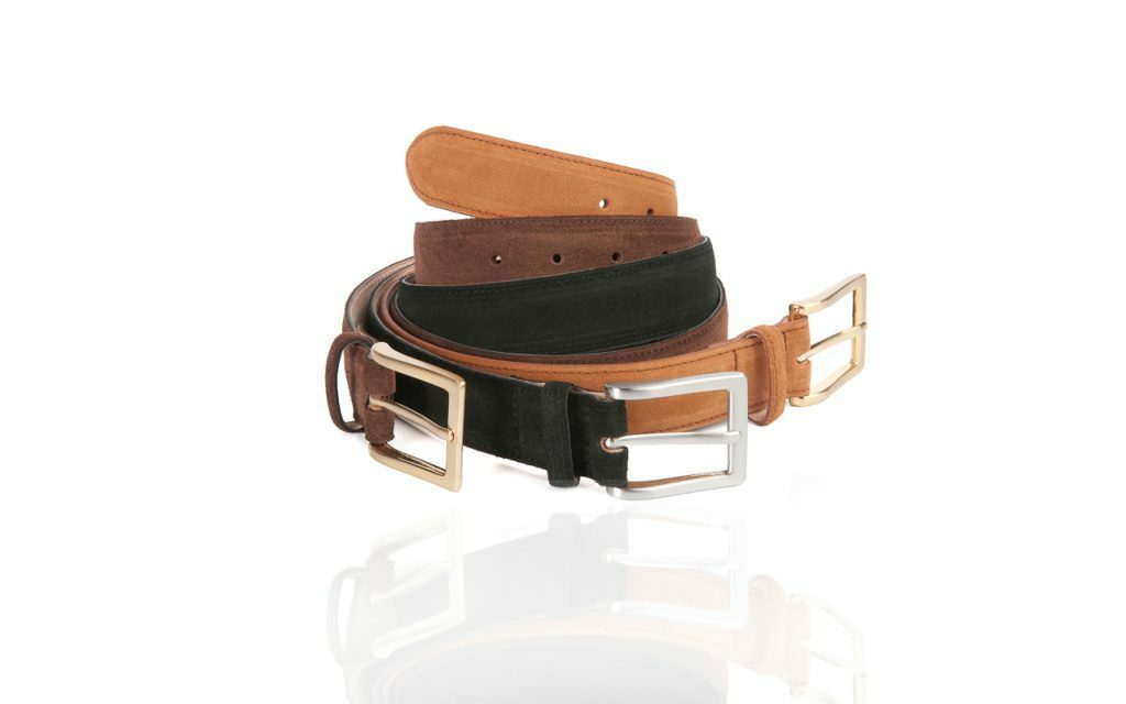Catalogue photograph of belts on a white background with reflection