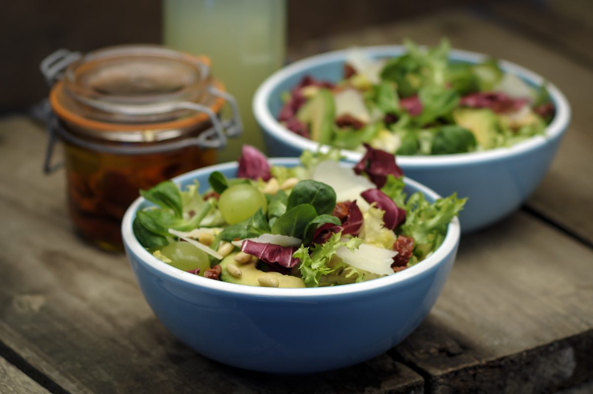 Two bowls of mixed leaf salad