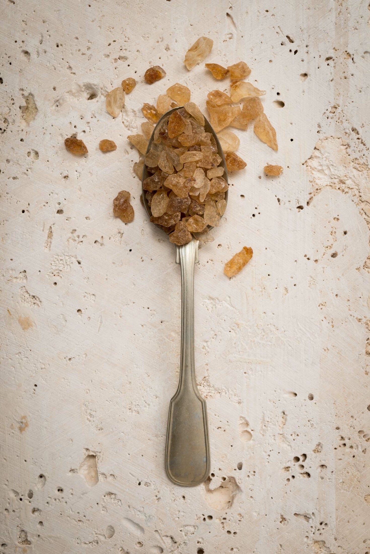 Teaspoons filled with sugar crystals