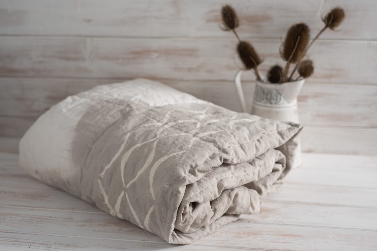 Rolled Two-Tone White and Gray Duvet with Thistle Plants